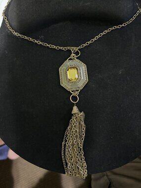 22" Gold tone chain and medallion with gold like chain tassels.